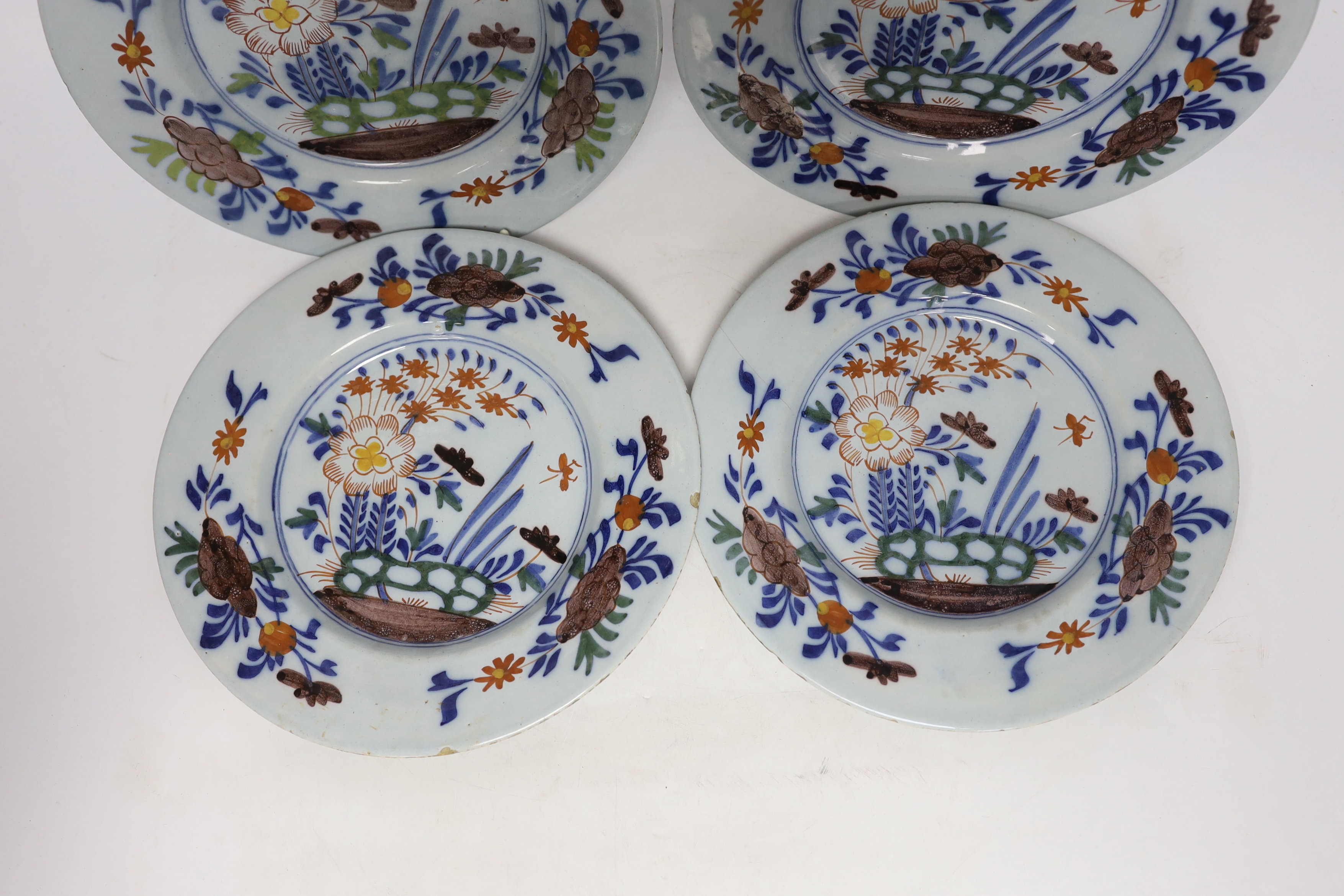 A set of four mid 18th century Delft polychrome floral plates, 22.5cm diameter